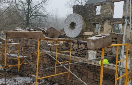 stone building with scaffolding in winter