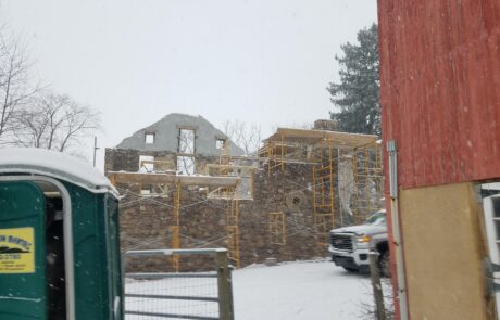 stone building under construction in winter