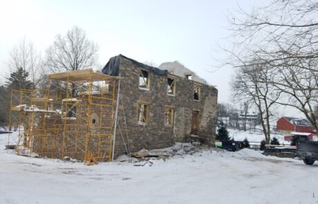 stone building under construction in winter