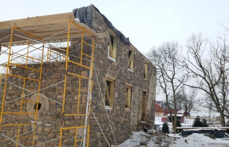 stone building under construction in winter