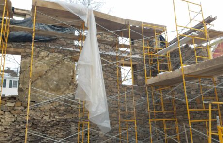 stone building under construction with scaffolding