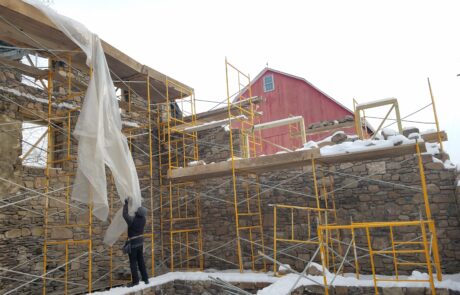 stone building under construction with scaffolding