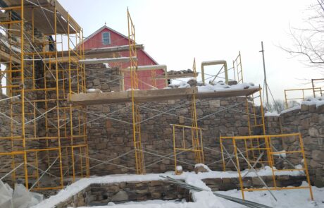 stone building under construction with scaffolding