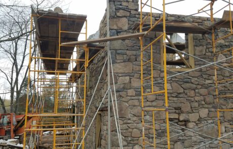 stone building under construction with scaffolding