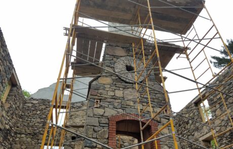 chimney under construction with decorative circle stone