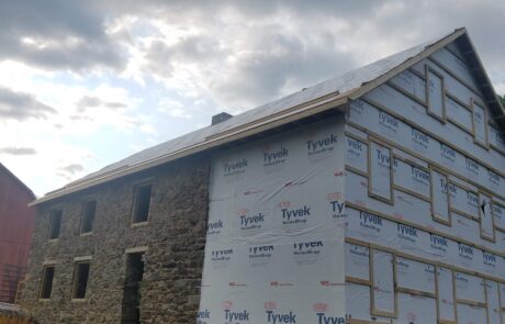 home wrap on stone building