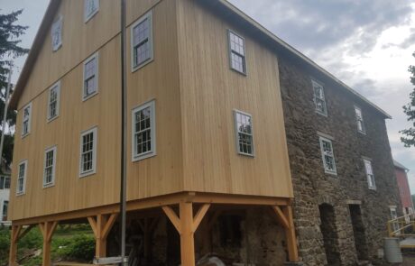 wood siding on stone building