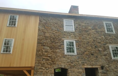 wood siding on stone building