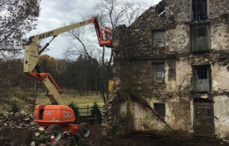 building deconstruction with cherry picker