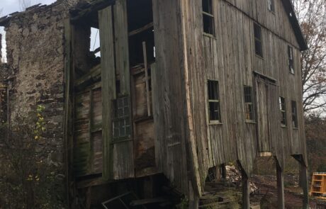 wood portion of building rotting and falling apart